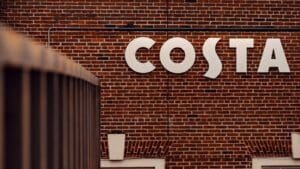 a brick wall with a sign that says costa on it