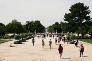 a group of people walking on a path in a park